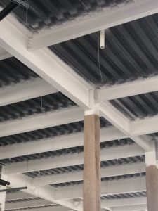 The interior of an industrial building, which it's structural beams being recently treated with intumescent fire-resistant materials